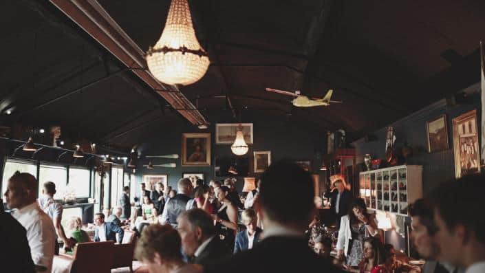 people having chat during drink reception inside building