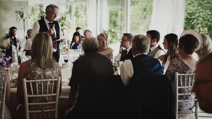 Bride and groom listening father speeches