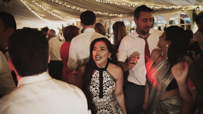 Wedding guest dancing on the dance floor with smiling faces