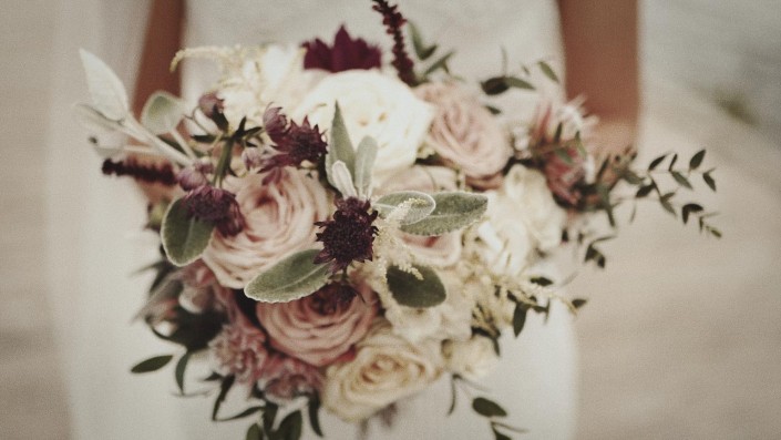 Bride is holding wedding bouquet