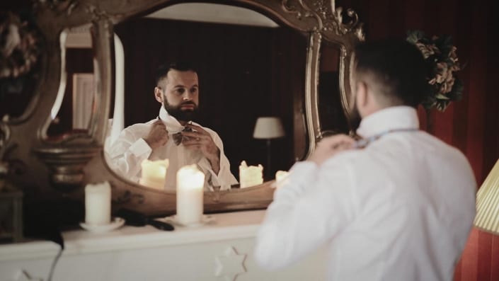 Groom is tiding wedding bowl in Ashley Park House