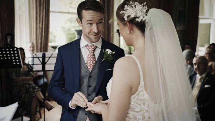 John putting wedding ring to Jayne