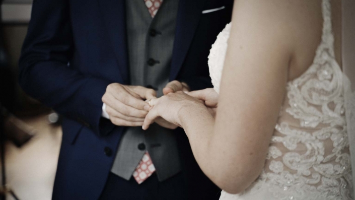 Close look at hands with ring when John is making eclaration