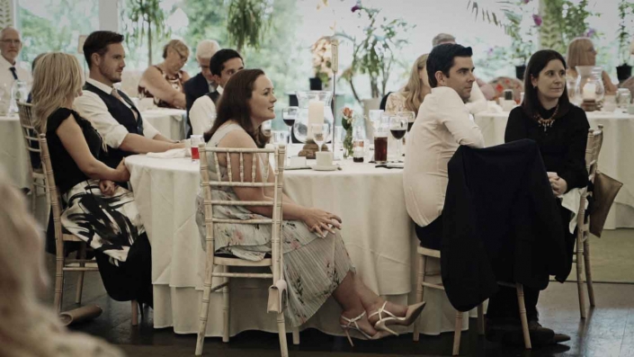 Wedding guest listening groom speech