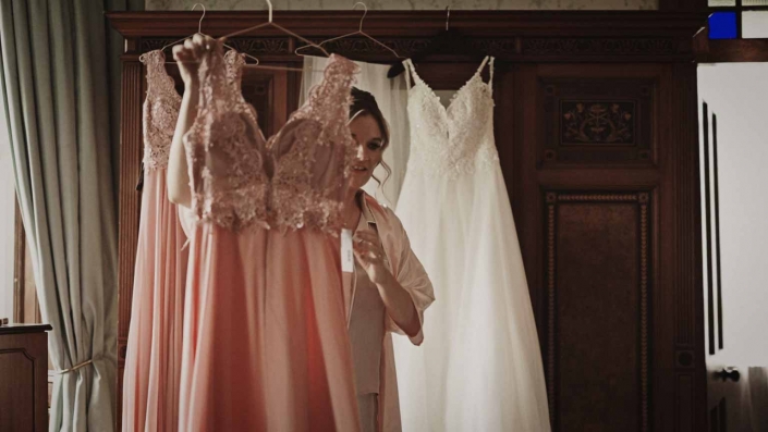 Bridesmaid taking her dress.