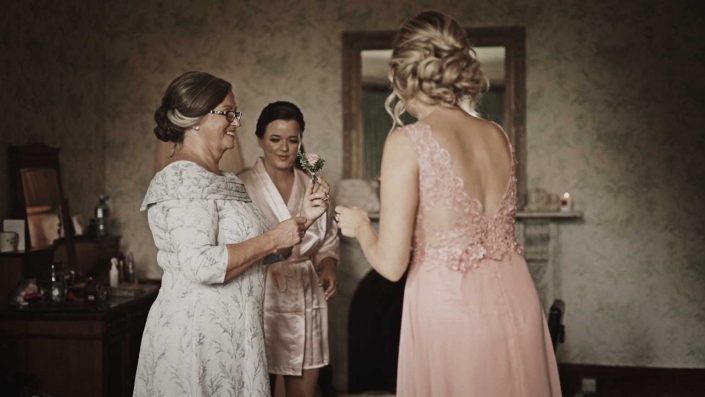 Bridesmaids helping with buttonhole flowers