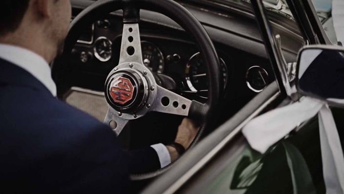 John is turning of wedding car with look at sport steering wheel