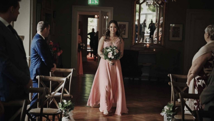 Sister of bride walking down the aisle