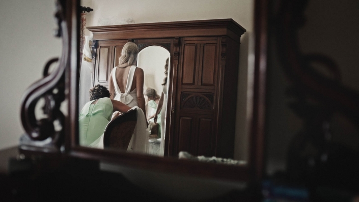 Bride is dressing wedding dress