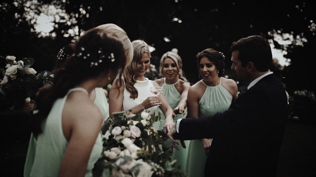 Bridesmaids admiring wedding ring on bride hand
