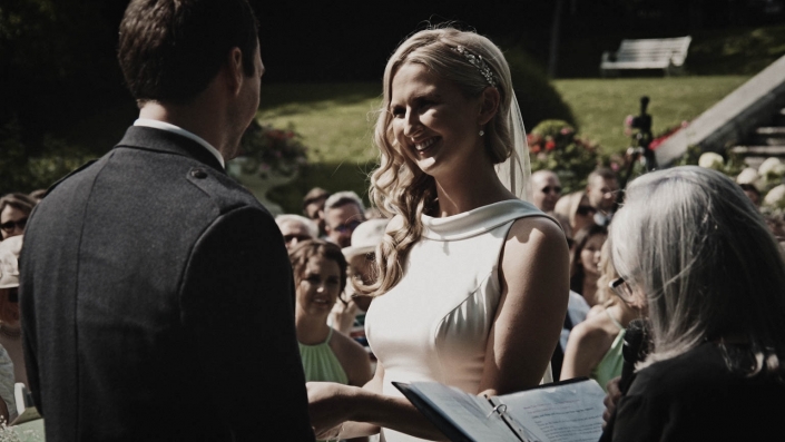 Bride is putting wedding ring on groom finger