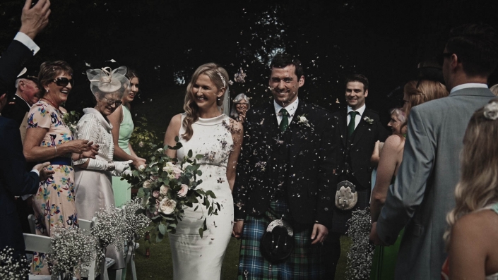newly couple waking thru confetti