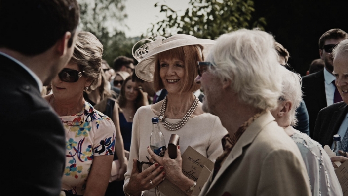 smiling wedding guest in cure to congratulate newly couple