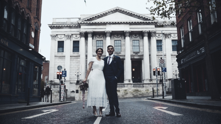 wedding photo with city hall in background