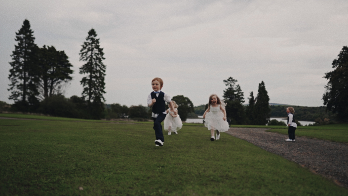 Page boy and flower girls running happily.