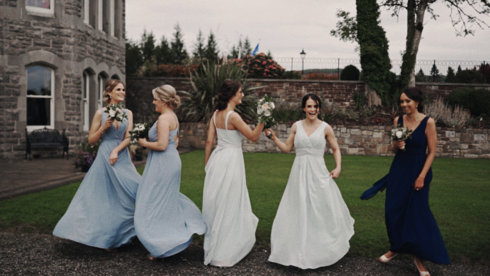 Bridesmaids are presenting their dresses.