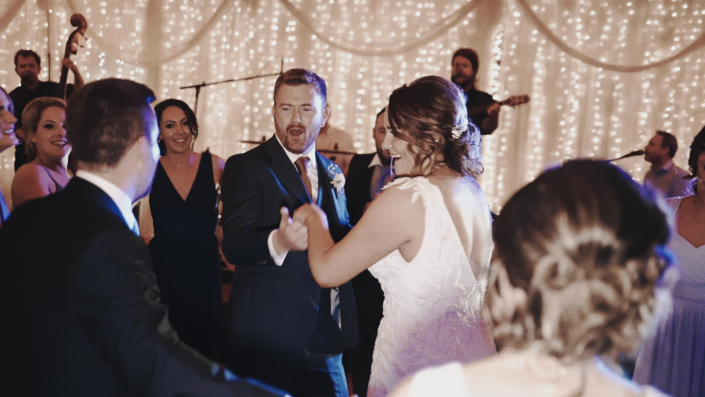 Bride wit groom enjoying first dance.