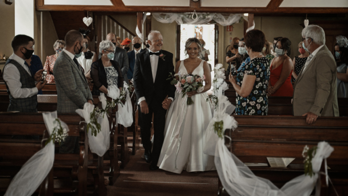 Gemma bride walking down the aisle