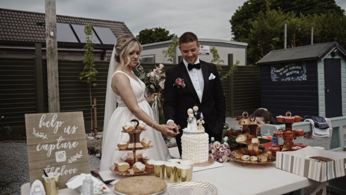 Gemma and Cian cut wedding cake