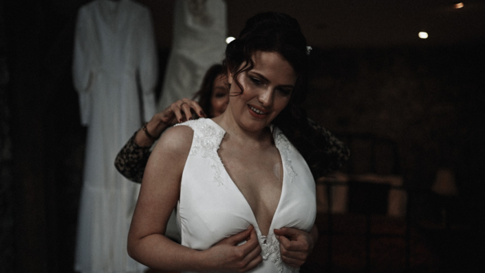 bride is putting wedding dress